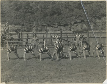Line, left to right: Paul Phipps; Arnold Lilly; Rudolph Suber; Bill Jenkinson; Ernie Moore; "Mose" Lilly; and Dick Gunnoe.Backfield, left to right: Emerson Carden; Ray Surbaugh; and "Tootie" Wood.Quarterback is Charlie Pollock.