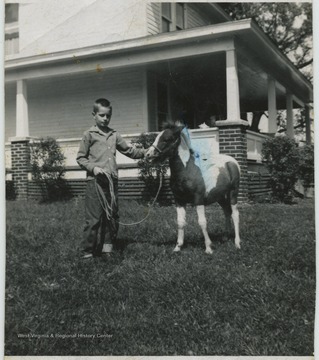 Maddy pictured in front of his home with a colt. 