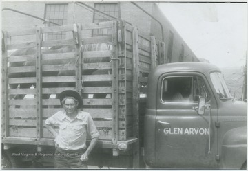 Gill pictured in front of the truck loaded with horses. The side of the truck reads, "Glen Arvon".