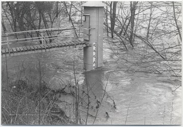 Gauge at the Willowood Bridge is pictured with water at the "23" mark, probably measuring in feet.