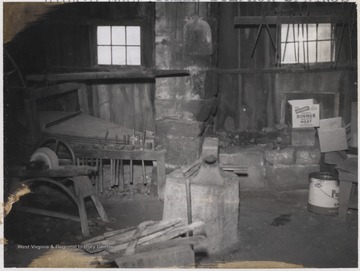 Built ca. 1884, the interior of the shop shows blacksmith equipment and supplies. 