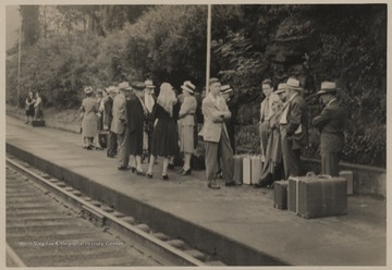 People wait at the station for the train en-route to Kiwanis International Convention. 