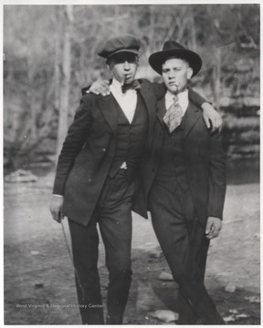 Meador, left, and Farley, right, pose with cigars in their mouths.