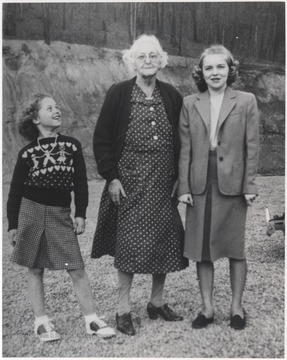Pictured on the left is Melba Meador, daughter of Luther Meador. Janice Meador Lilly, daughter of Foy Meador, is pictured on the right. The group is pictured near the construction site of Bluestone High Bridge. 
