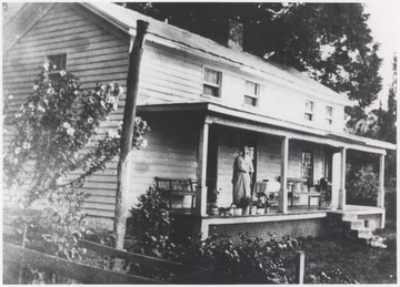 Bradberry pictured on her porch beside potted flowers. The home is located at Crump's Bottom. 