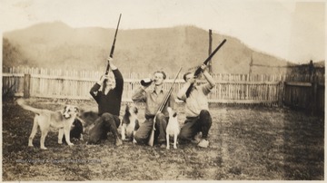 James David Neely (left), Luther L. Meador (center), and C. Brade Neely (right) holding guns, perhaps used for hunting, and sitting with their dogs. Meador sips from a bottle in the middle.The farm is now known as Meador Camp Ground at Bluestone State Park. 