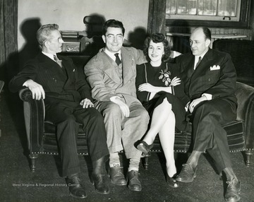 Center left: Tom Whitley, orchestra leader of the Musical Steelmakers of the Wheeling Steel Corporation. Center right: Regina Colbert, singer on "It's Wheeling Steel" radio program and secretary in advertising office.  In 1943 the "It's Wheeling Steel" radio program took to the road throughout several cities in West Virginia to put on "Buy a Bomber" themed shows, where the host cities were challenged to buy enough enough Defense Bonds to purchase a medium or large sized bomber. Cities who accomplished the challenge would get their name placed on the plane as it flew to battle.