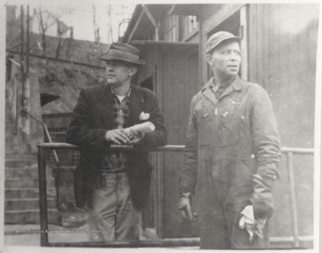 G. W. Conner, left, and Charles Johnson, right, stand outside the roundhouse building. 