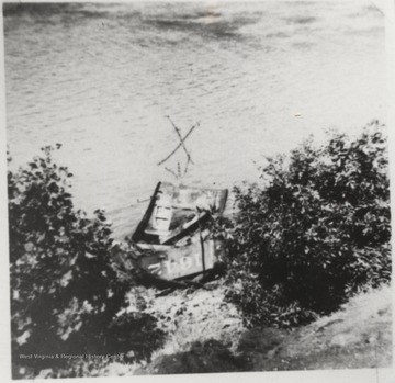 The "X" on the photo marks the spot where fireman J. W. Sullivan was found dead. Parts of the engine are pictured in the river. 