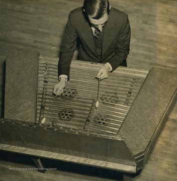 Caption accompanying photograph reads: "Val Konyha, a steelmaker from the Yorkville Works brings something unique and different to the family broadcast. Val plays the Hungarian cymbalum, or dulcimer, as we know it, and plays it as well as he handles tin plates."
