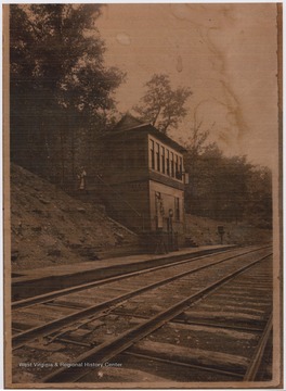 View of the office from across the railroad tracks. And unidentified woman is pictured looking over the staircase. 