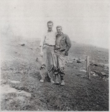 Denver and Benny Cook are pictured together in front of a wire fence.