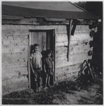 Larry and Wanda Lilly pictured at a doorway to the log home located on Leatherwood Road.
