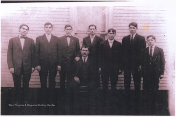 Pictured standing from left to right is Walter, George, Harry, Roy, Frank, Raymond, and Cecil.
