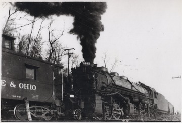 Smoke billows from the engine which sits behind twenty-eight cars of coal. The photo was taken on the east end of Meadow Creek. 