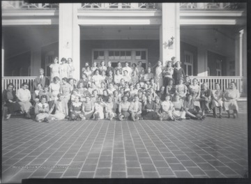 Female students and their teachers are pictured in front of the building. Subjects unidentified. 