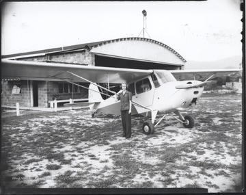 An unidentified woman poses beside the plane.