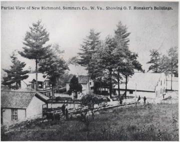 Buildings belonging to O. T. Honaker Lumber Yard pictured with part of the town.
