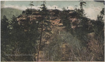 Drawn, colored depiction of the view from the C. & O. Railway. Two figures are pictured on top of a large rock formation.Published by J. A. Graham & Co.