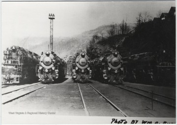 The locomotives sit on the tracks below the pit.