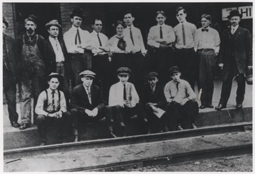 A group of unidentified individuals pose on the street together.