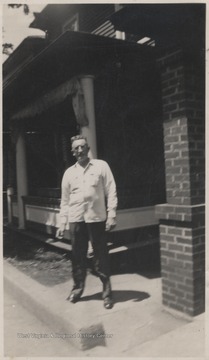 Hunt, described on the back of the photo as "Pat's boyfriend" is pictured outside a home on Summers Street.
