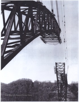 Photo of the steel bridge being put together by the United States Steel Corporation. The bridge's arch was the world's longest main arch at 1,700 feet. 
