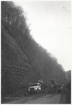 A truck collects the fallen rock from Route 20 below Bluestone Dam.