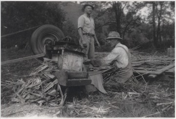 Mark Shumate (standing) and Luther Shumate perform chores on the farm grounds located near War Ridge.