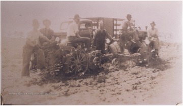 A group of six men harvest potatoes outside of the sanitarium. Subjects unidentified. 