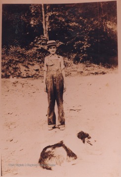 Charles wears the clothing of his recently deceased grandfather, William Alexander Wood. In the forefront of the photograph is the family dog, "Old Shep". 