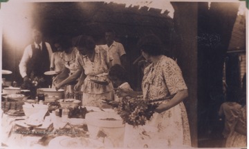 Family members prepare plates from a buffet. 