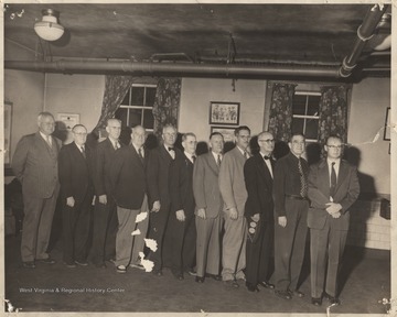 From left to right is W. J. B. Simmons; Ronald Meadows; unidentified; P. J. Carr, Sen.; unidentified; Henry Harrison; unidentified; Dr. J. W. Stokes; Dr. Meador; unidentified; Dr. Buford McNeer. The men are pictured inside the Peck Building. 