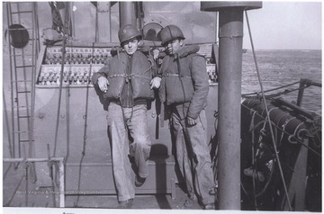Trail (left) and his comrade are pictured on a battleship during what is sometimes called the Asia-Pacific War during World War II.