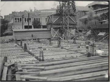 Two unidentified construction workers pictured on the site of what is to become the Hall of Chemistry. 
