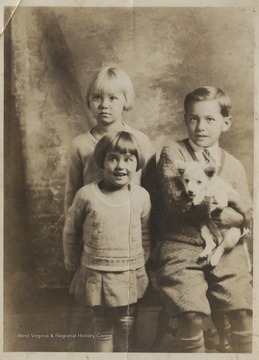 Phylis, Madge, and Roy Lee Honaker pictured with their family pet. 