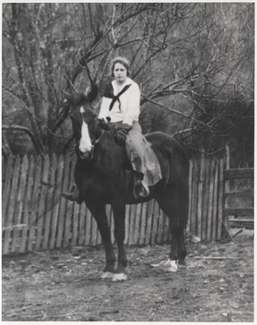 Richmond, neice of Luter Meador, is pictured straddling a horse. 