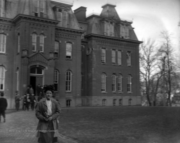 Image shows female student leaving Woodburn Hall and other students entering Woodburn Hall.