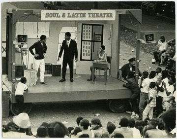 The Soul and Latin Theater performed plays dealing with cultural issues of the 1960s that were also related to the lives of the actors.  They used a mobile stage on wheels to move to different street or park locations.Maryat Lee (born Mary Attaway Lee; May 26, 1923 – September 18, 1989) was an American playwright and theatre director who made important contributions to post-World War II avant-garde theatre.  She pioneered street theatre in Harlem, and later founded EcoTheater in West Virginia, a community based theater project.Early in her career, Lee wrote and produced plays in New York City, including the street play “DOPE!”  While in New York she also formed the Soul and Latin Theater (SALT), and wrote plays centered around the lives of the actors in the group.In 1970 Lee moved to West Virginia and formed the community theater group EcoTheater in 1975.  Beginning with local teenagers from the Governor’s Summer Youth Program, the rural theater group grew, and produced plays based on oral histories collected from the local community.  Each performance of an EcoTheater play involved audience participation and discussion.  With the assistance of the Humanities Foundation of West Virginia, guest scholars became a part of EcoTheater.