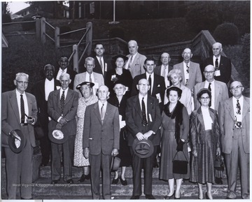 The former employees pose for a group portrait. Pictured is Mr. and Mrs. M. J. Hinton, Mr. and Mrs. R. F. Wilson, Mr. and Mrs. M. L. Richmond, Mr. and Mrs. Whitlock, Henry Lee, Thomas Haskins, Mr. and Mrs. W. H. Thomas, Mr. and Mrs. Krim Bess, Mr. King, J. W. McCallister, Jr., D. B. Murphy of Clifton Forge, Va., E. L. Wiseman, Mr. Reese, and W. L. Taylor. The group was attending the 38th convention of the Veterans' association held in Greenbrier Valley Fair Grounds. 