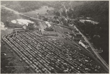 View of the vast lumber yard, grounds, and company buildings.The photographer, Tom Ocheltree (1926-1990) was a railroad employee with a side business of commercial photography. This image, and two other aerials, appeared as 5x7 enlargements for the East Rainelle bus depot. 