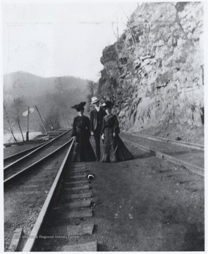 Mrs. Murrell, left, is pictured with an unidentified man and unidentified woman beside the track. 