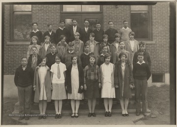 A group of high school students pose outside the building. Subjects unidentified.