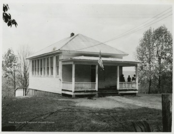 School children are pictured on the porch. Subjects unidentified. 