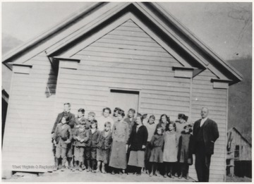 "Big" George Lilly and his students pose outside of the schoolhouse. 