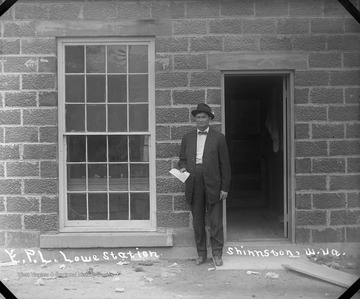 An unidentified man stands outsides the E.P.L. Lowe Station.