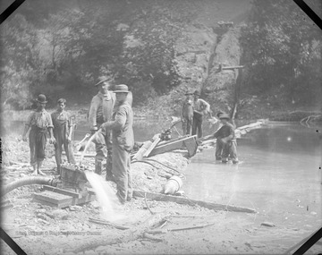Men likely working on an oil pipeline construction in a body of water. 