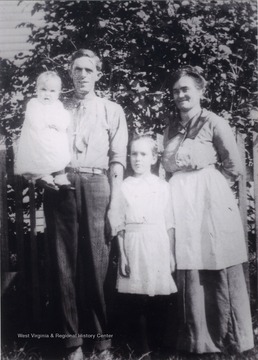Family portrait of Lydia Hanna Barr Ballangee, her husband, and daughters, Pauline and baby Madeline.