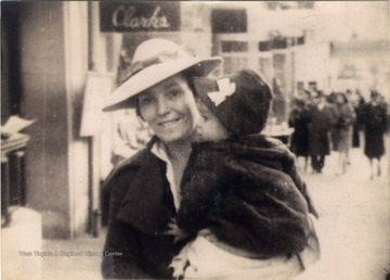 Pauline Barr Sirk holding her youngest daughter, Mary, on a street in Terra Alta, West Virginia.