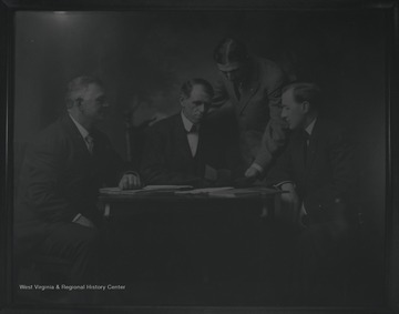 Rufus Switzer and the first commissioners sitting around a table